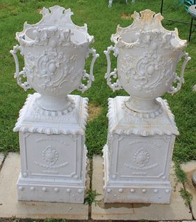 An Antique Pair Of Cast Iron Urns On Stands