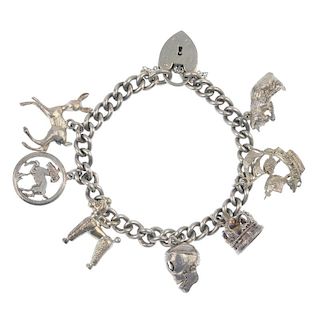 Three charm bracelets and some loose charms. Suspending twenty-two charms, to include a key, a poodl