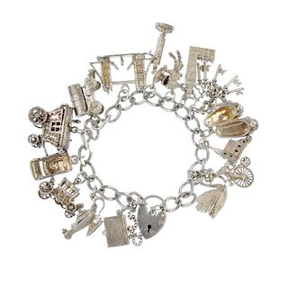 Two charm bracelets. Suspending a total of twenty-eight charms, to include a palm tree, a bunch of k