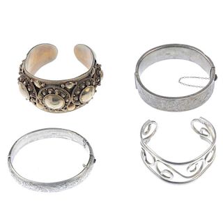 A selection of silver and white metal bangles. To include gem-set bangles together with hinged and c
