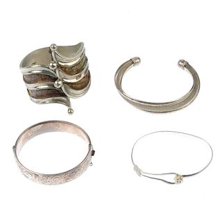 A selection of silver and white metal bangles. To include a torque bangle with inlaid gem detail dep