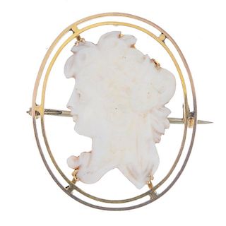 A cameo brooch. The carved white shell section mounted to an open oval-shape surround. Mark indicati