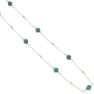 A malachite necklace. The alternating malachite and plain beads, spaced along the flat curb-link cha