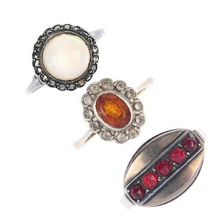 A selection of dress rings. To include a cultured pearl and marcasite ring, an orange paste and colo