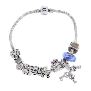CHAMILIA - a charm bracelet. With six Chamilia charms and three non-designer charms, including a blu