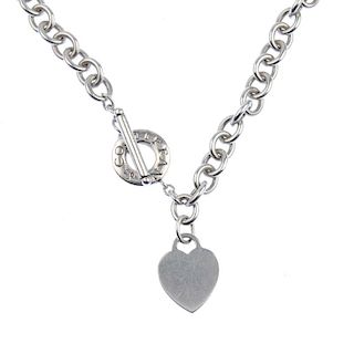 TIFFANY & CO. - a necklace. The belcher-link chain suspending a heart-shape panel, to the T-bar clas