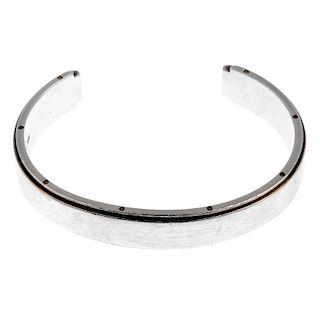 TIFFANY & CO. - a bangle. The open bangle with screw detail to the edges and plain front. Signed Tif