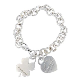TIFFANY & CO. - a bracelet. The chain-link bracelet suspending a heart-shape 'Please return to Tiffa