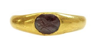 A Roman high carat gold garnet intaglio ring,