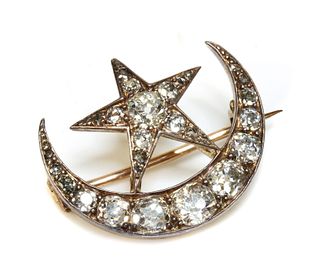 A late Victorian diamond set crescent and star brooch,