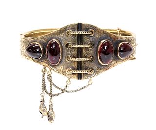 A Victorian gold garnet set hinged bangle, c.1860,