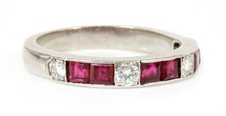 A ruby and diamond half eternity ring,