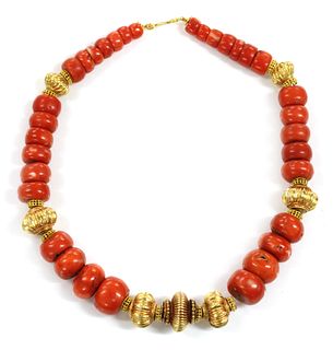 A single row graduated coral and high carat gold bead necklace,