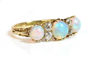 A Victorian seven stone opal and diamond carved head style ring,