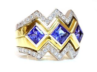 A gold three stone tanzanite and diamond ring,