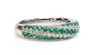An 18ct white gold emerald and diamond half hoop ring,