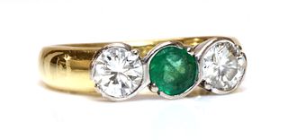 An 18ct gold emerald and diamond three stone ring,