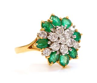 A two colour gold, diamond and emerald cluster ring,