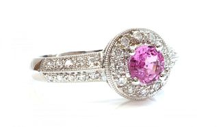 An 18ct white gold pink sapphire and diamond halo cluster ring,