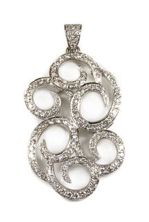 A white gold diamond set scrolling pendant,