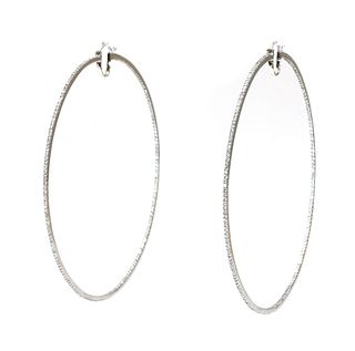 A pair of large white gold diamond set hoop earrings,