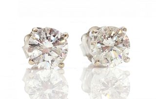 A pair of 18ct white gold single stone fracture filled diamond stud earrings,