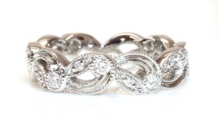 An 18ct white gold pierced diamond set band ring,