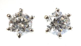A pair of white gold single stone diamond stud earrings,