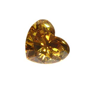 An unmounted fancy orangey yellow heart shaped brilliant cut diamond,