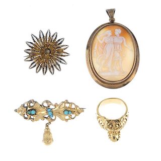 Four items of jewellery. The first a filgree work floral brooch, the second a ring designed as a tig