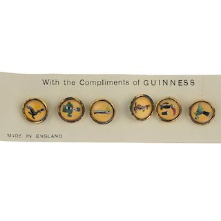 A set of six dress studs. Of circular outline, each depicting a character from the Guinness advertis