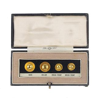 A set of early 20th century 9ct gold dress studs. Four plain gold dress studs, displayed in a fitted