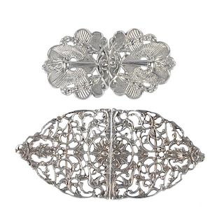 Eight mid to late 20th century silver buckles. One two-piece buckle with floral and scrolling openwo