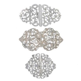 Seven early to late 20th century silver buckles.To include an openwork buckle engraved with clover,