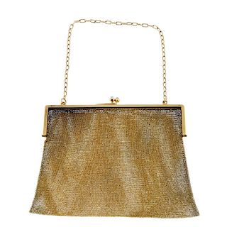 An early 20th century gold mesh bag. The 20ct gold square frame to the blue sapphire kiss clasp and
