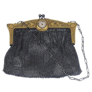An early 20th century mesh bag. The dragon and foliate decorative frame with watch head detail, to t