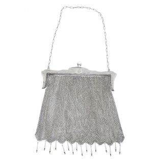 An early 20th century silver mesh bag. The shaped frame with scalloped outline, to the clip clasp an
