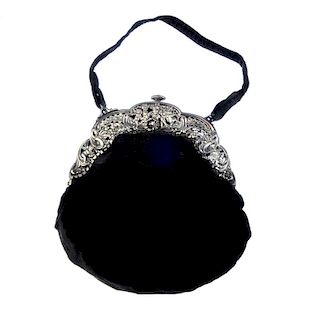 <p>An early 20th century silver mounted velvet purse, the black velvet purse, to the openwork silver