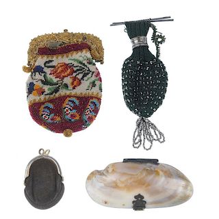 A selection of early 20th century purses. To include a clam shell coin purse, a miniature suede purs