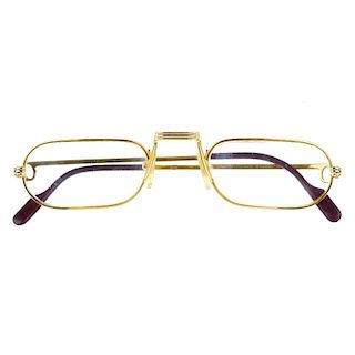 CARTIER - a pair of prescription glasses. Designed with narrow oblong shaped clear glass lenses, gol