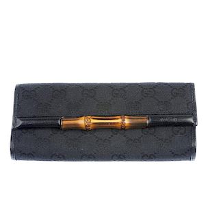 GUCCI - a Bamboo Bar Clutch. Featuring maker's signature GG monogram canvas in black with black leat