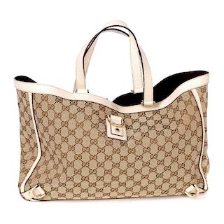 GUCCI - an Abbey Tote. Crafted of maker's GG beige monogram canvas, featuring an ivory leather trim,