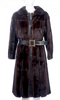 A full-length ranch mink and leather panelled coat. Designed with a small notched lapel collar, hook
