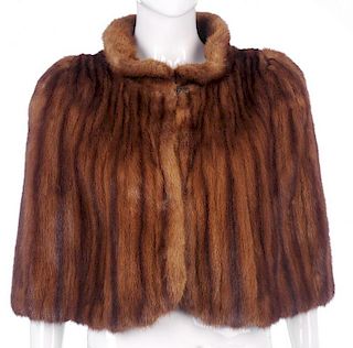 A 1940s wild mink cape. Designed with a short Peter Pan collar, a single hook and eye fastening, fit