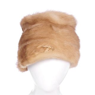 Three fur hats. To include two pastel mink hats, one with paw and tail details, together with an oce