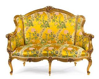 A Louis XV Style Giltwood Canape a Oreilles Height 47 x width 55 x depth 27 inches.