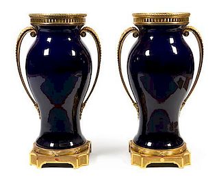 A Pair of French Gilt Bronze Mounted Cobalt Glazed Ceramic Urns Height 33 inches.