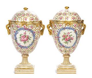 A Pair of Continental Porcelain Urns and Covers Height 16 1/2 inches.