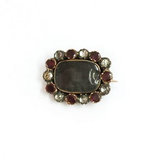 A Georgian gold and silver, garnet and paste memorial brooch,