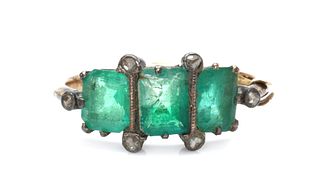 A gold and silver, emerald and diamond ring,